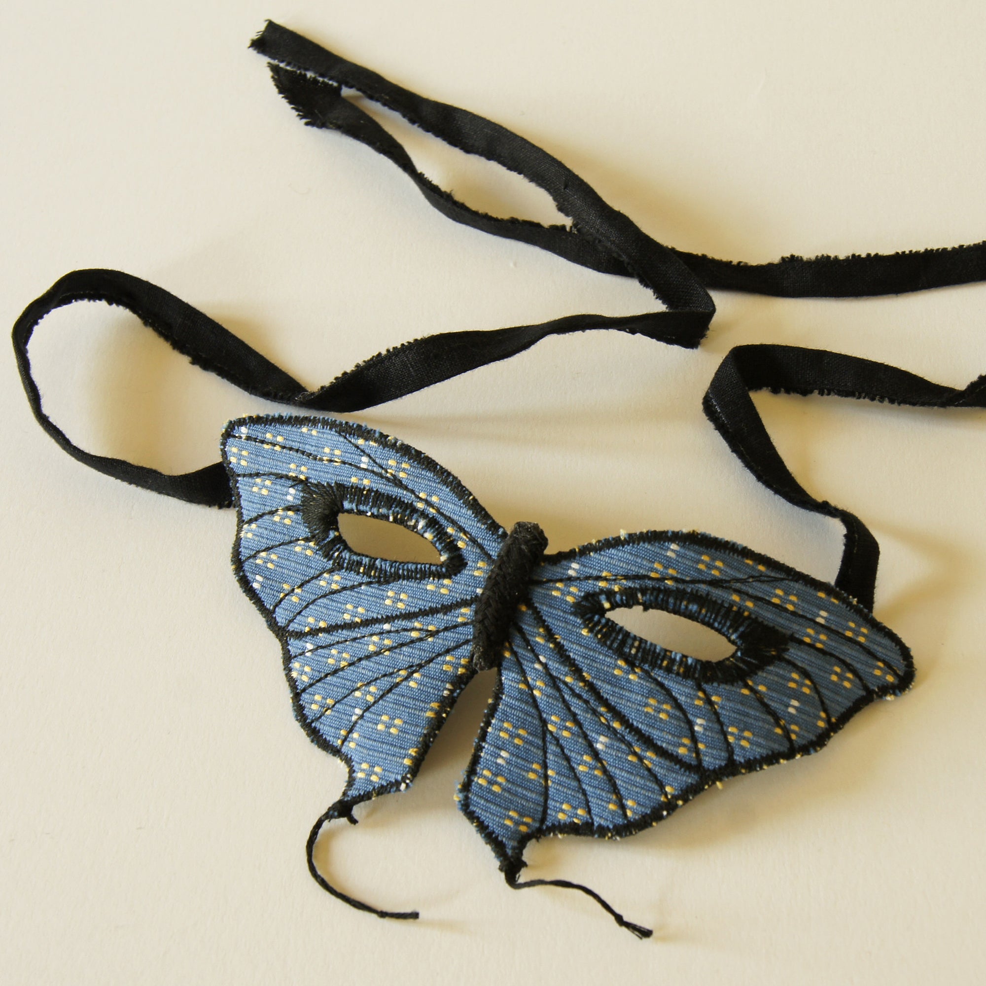 Tailed butterfly mask in blue upholstery fabric