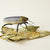 Jewel Beetle textile sculpture with textile leaf