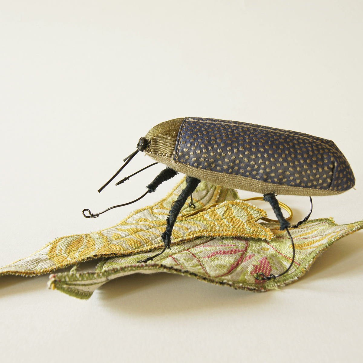 Jewel Beetle textile sculpture with textile leaf
