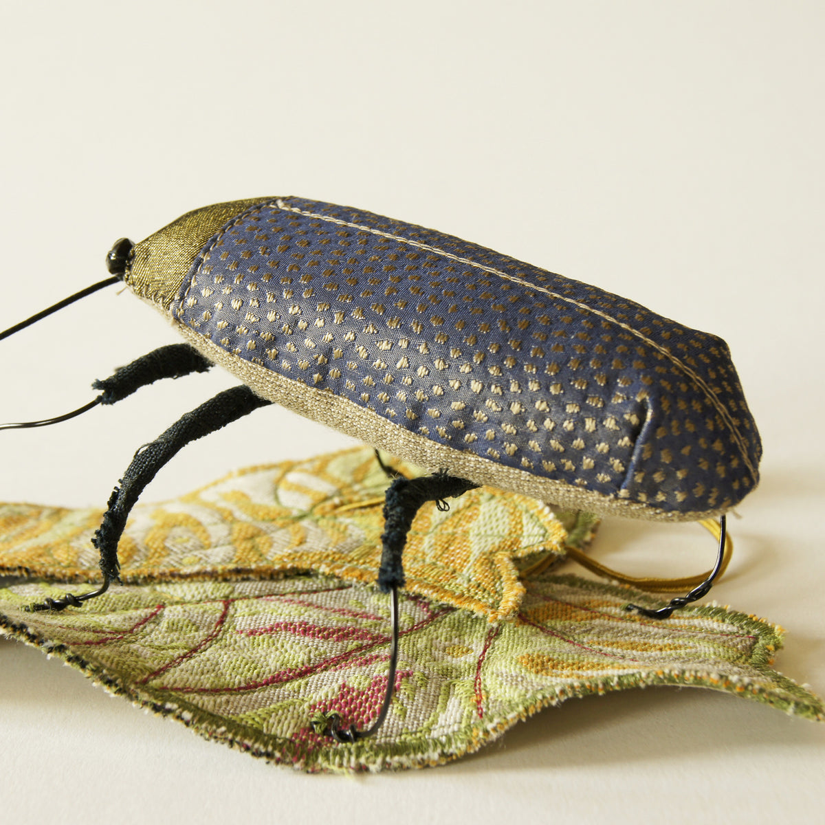 Jewel Beetle textile sculpture with textile leaf
