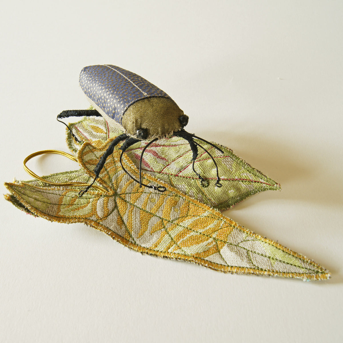 Jewel Beetle textile sculpture with textile leaf