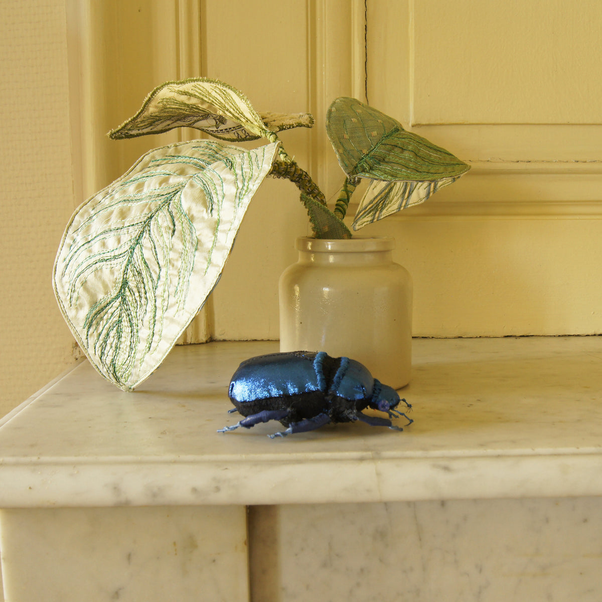 Blue jewel scarab and philodendron leaves textile sculpture