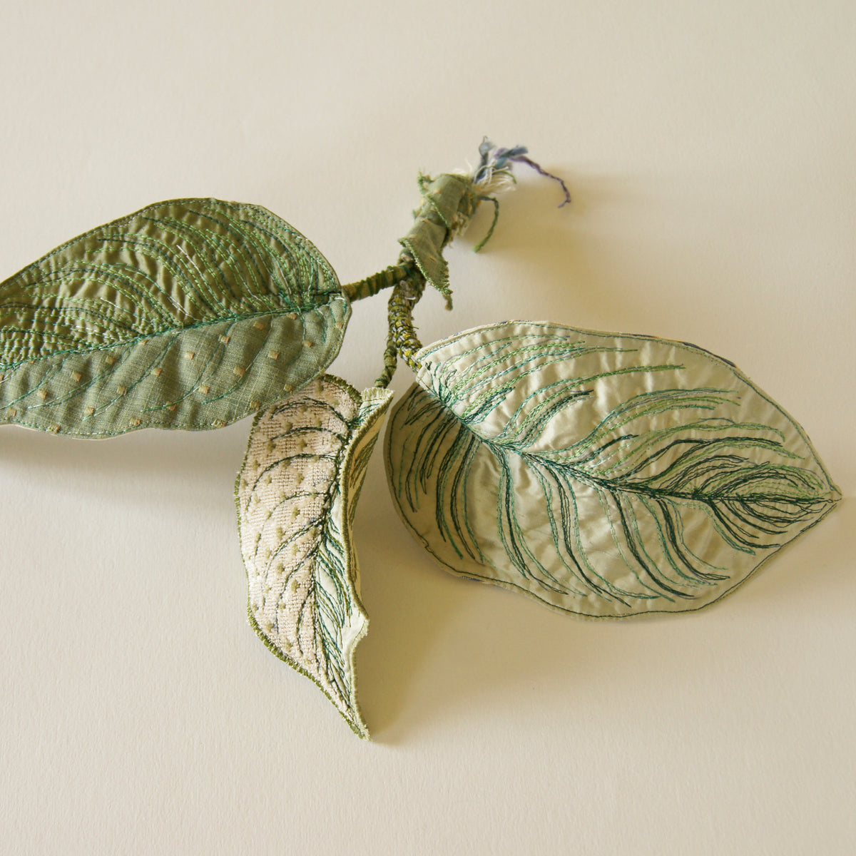 Blue jewel scarab and philodendron leaves textile sculpture